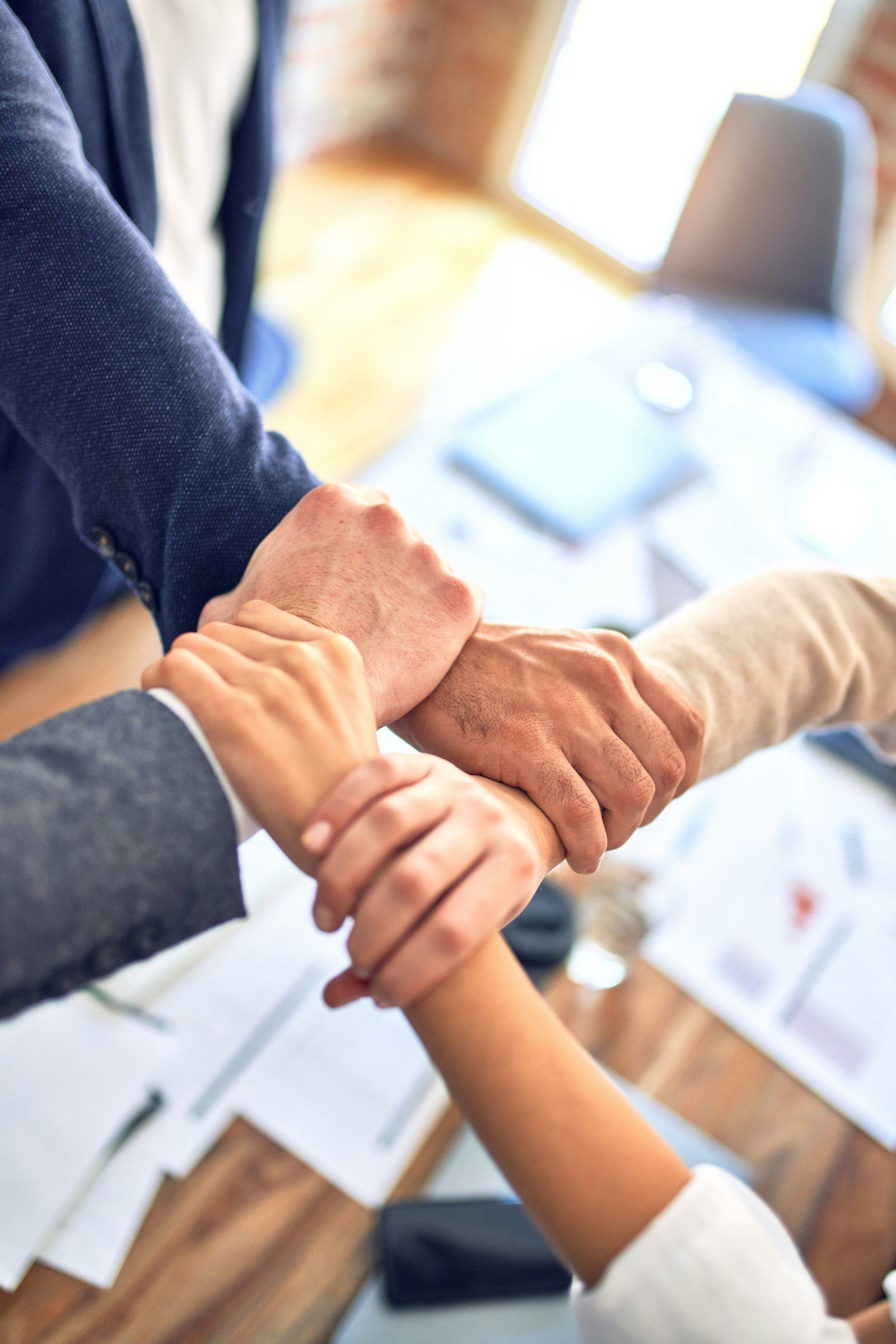 Team members joining hands together
